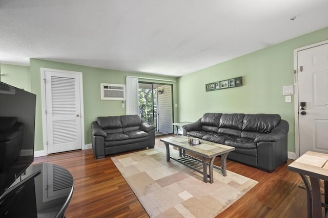 1410 Skyline Dr Unit 11, Lowell, MA 01854 - living room with wood finished floors, a wall mounted air conditioner, and baseboards
