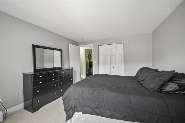 1410 Skyline Dr Unit 11, Lowell, MA 01854 - carpeted bedroom with baseboards, a closet, and a textured ceiling