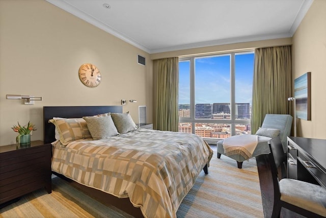 bedroom featuring ornamental molding and a city view