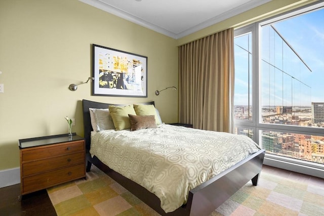 bedroom featuring wood finished floors and crown molding
