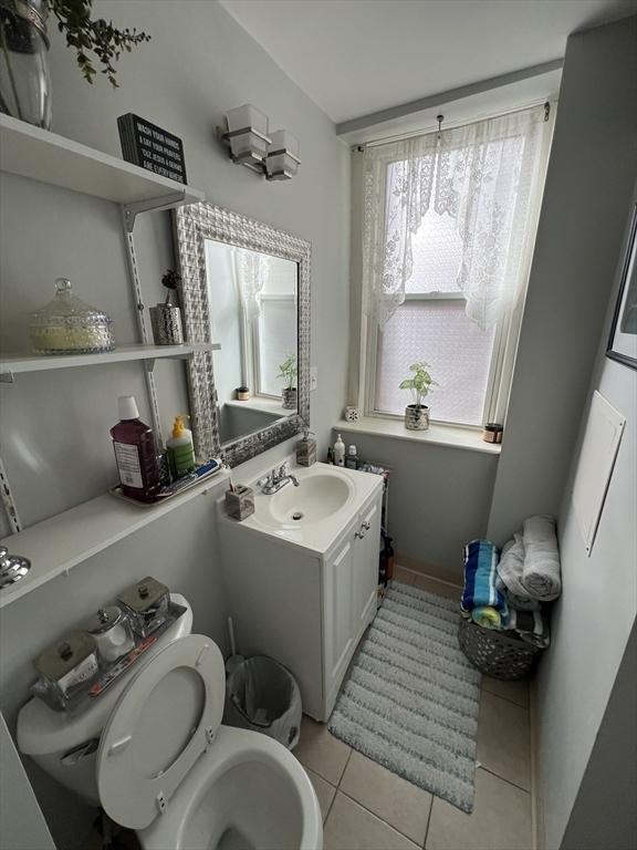 bathroom featuring vanity, tile patterned floors, and toilet