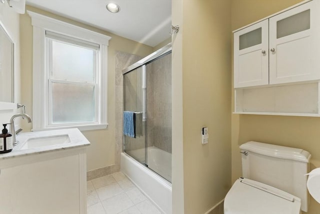 200 Winchester St Unit 1, Brookline, MA 02446 - full bathroom with baseboards, toilet, combined bath / shower with glass door, tile patterned flooring, and vanity