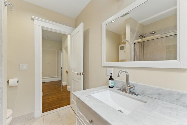 200 Winchester St Unit 1, Brookline, MA 02446 - bathroom featuring vanity, a tile shower, toilet, tile patterned floors, and baseboards