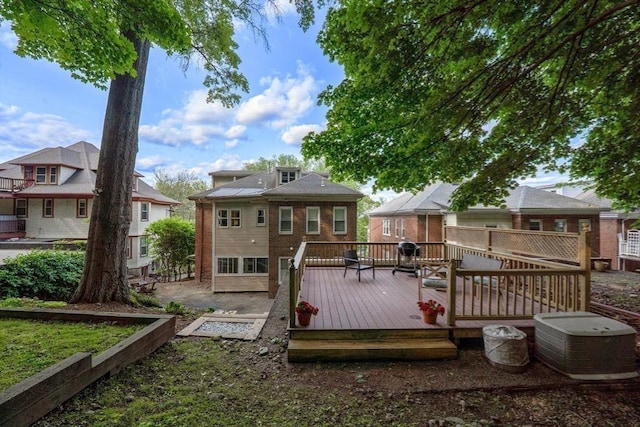 200 Winchester St Unit 1, Brookline, MA 02446 - back of house featuring a deck and brick siding