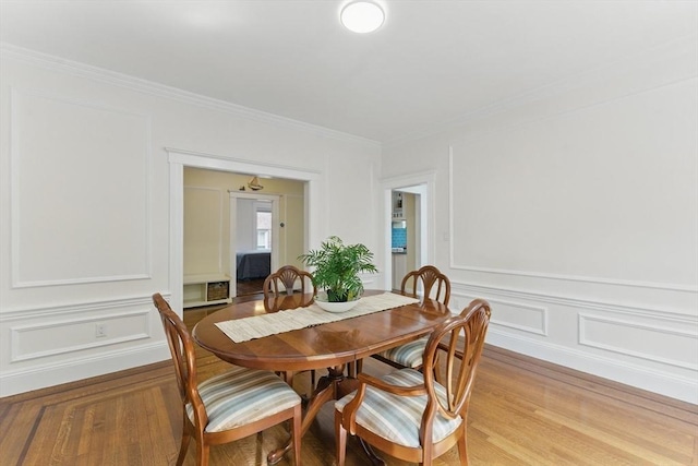 200 Winchester St Unit 1, Brookline, MA 02446 - dining space with a decorative wall, light wood-type flooring, and crown molding