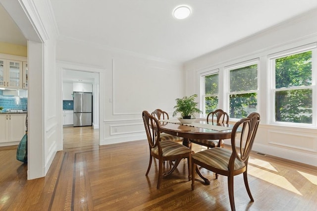 200 Winchester St Unit 1, Brookline, MA 02446 - dining room featuring a decorative wall, wood finished floors, and ornamental molding