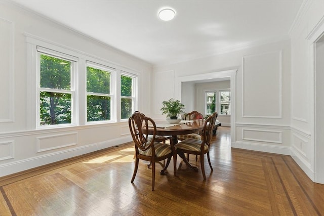 200 Winchester St Unit 1, Brookline, MA 02446 - dining space featuring a decorative wall, healthy amount of natural light, ornamental molding, and wood finished floors