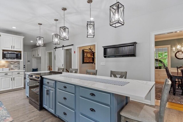 28 Sandy Ridge Rd, Sterling, MA 01564 - kitchen with electric range oven, built in microwave, a barn door, white cabinets, and blue cabinets