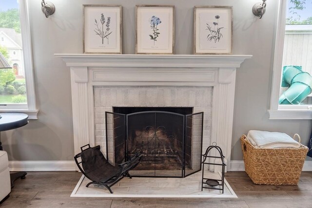 28 Sandy Ridge Rd, Sterling, MA 01564 - detailed view of a brick fireplace, wood finished floors, and baseboards