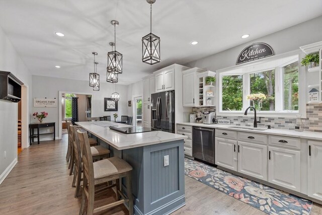 28 Sandy Ridge Rd, Sterling, MA 01564 - kitchen with fridge with ice dispenser, a sink, dishwasher, open shelves, and a kitchen island