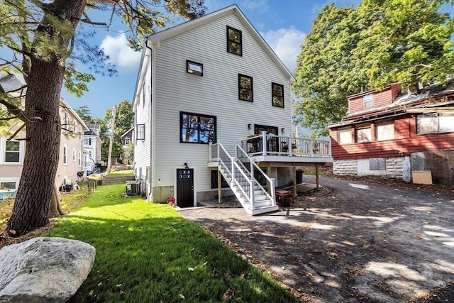 rear view of house with a deck, central AC, a yard, and stairway