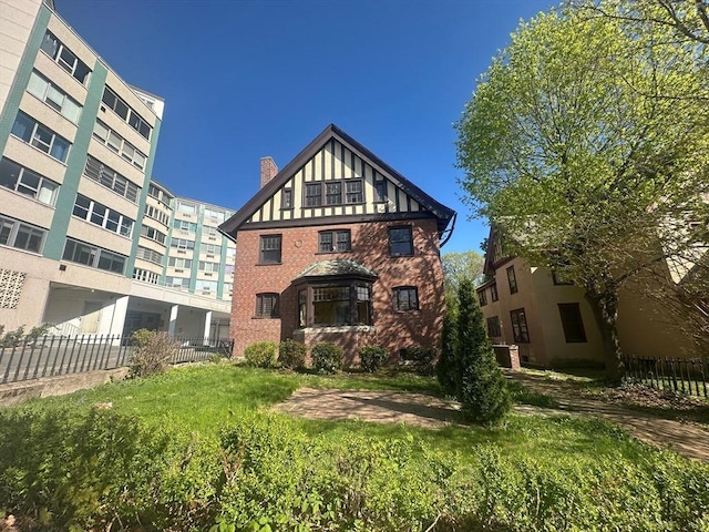 91-93 Mulberry St, Springfield, MA 01105 - exterior space featuring fence, a chimney, and brick siding