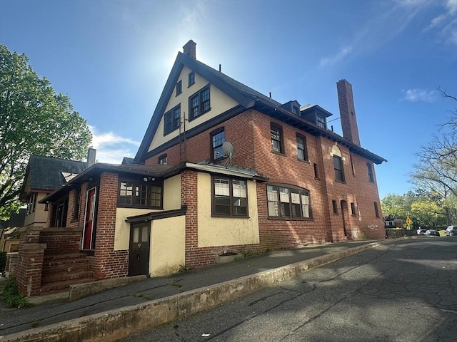 91-93 Mulberry St, Springfield, MA 01105 - view of side of property featuring a chimney and brick siding