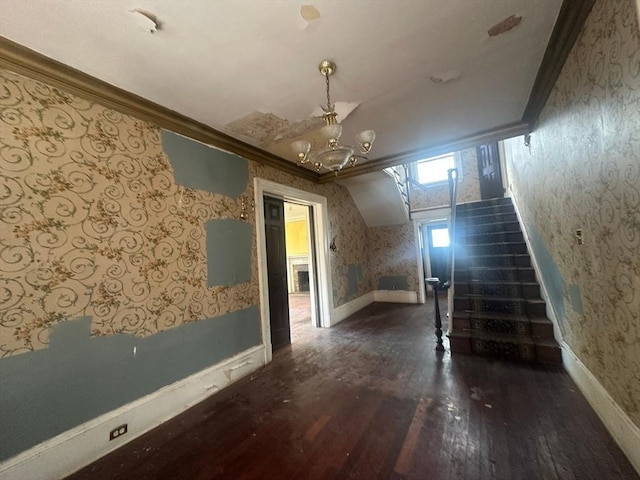 91-93 Mulberry St, Springfield, MA 01105 - unfurnished living room with crown molding, wallpapered walls, wood finished floors, and a notable chandelier