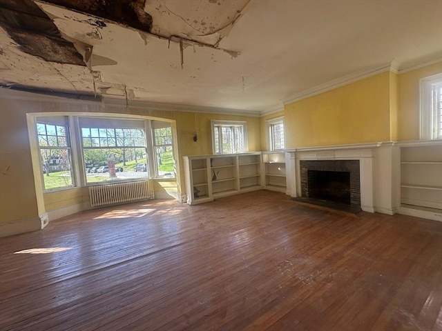 91-93 Mulberry St, Springfield, MA 01105 - unfurnished living room with a fireplace, radiator, a healthy amount of sunlight, ornamental molding, and hardwood / wood-style flooring