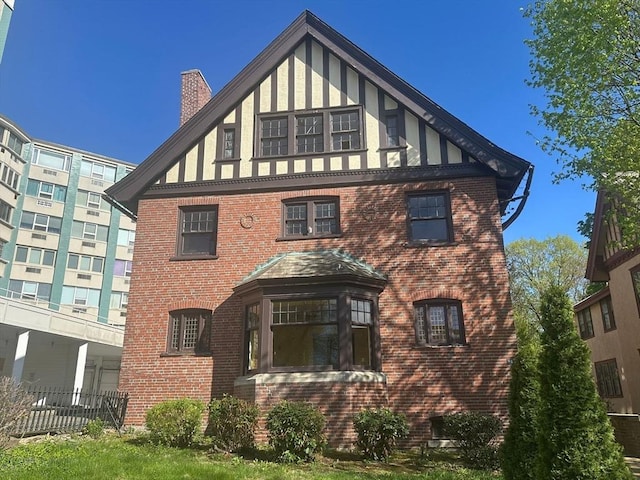 91-93 Mulberry St, Springfield, MA 01105 - exterior space with brick siding, a chimney, and central AC unit