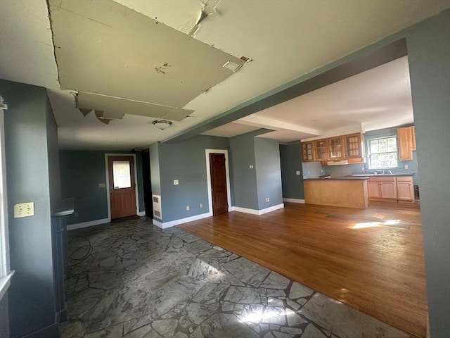 91-93 Mulberry St, Springfield, MA 01105 - unfurnished living room featuring a sink, baseboards, and dark wood-type flooring