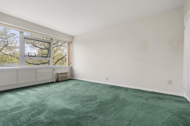 carpeted spare room with baseboards and an AC wall unit