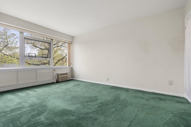 spare room with an AC wall unit, carpet floors, and baseboards