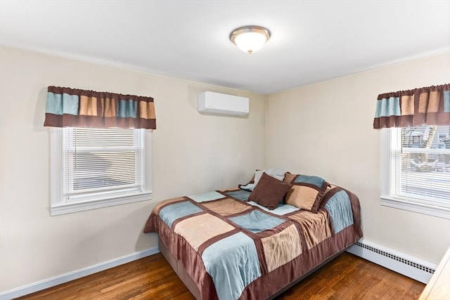 bedroom featuring baseboard heating, a wall mounted air conditioner, and dark hardwood / wood-style flooring