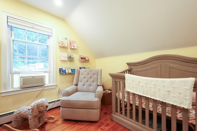 43 Thompson St, Maynard, MA 01754 - bedroom with vaulted ceiling, wood finished floors, a baseboard heating unit, and cooling unit