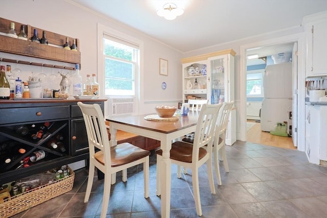 43 Thompson St, Maynard, MA 01754 - dining room with healthy amount of natural light, ornamental molding, and a bar