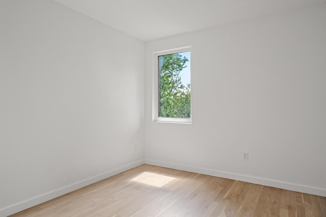 unfurnished room featuring light wood-type flooring and baseboards