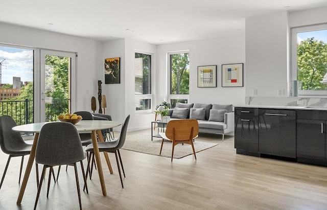 dining space with light wood-style flooring