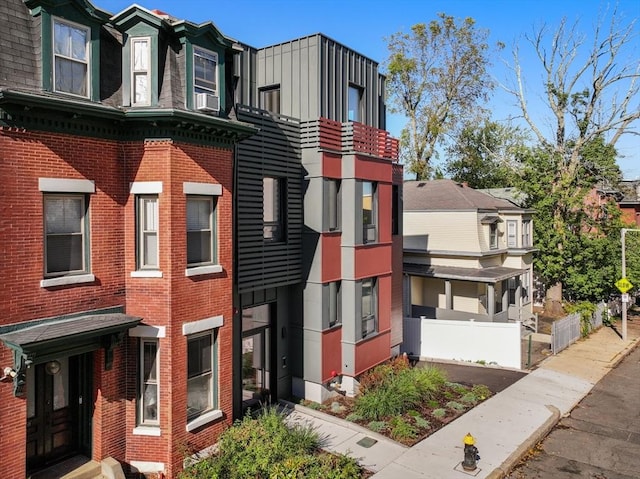 view of building exterior featuring cooling unit and a residential view