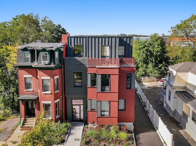 view of front of house featuring fence and brick siding