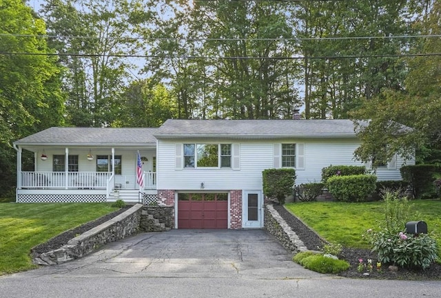 132 Biscayne St, Leominster, MA 01453 - view of front of property featuring a porch, asphalt driveway, a garage, and a front lawn