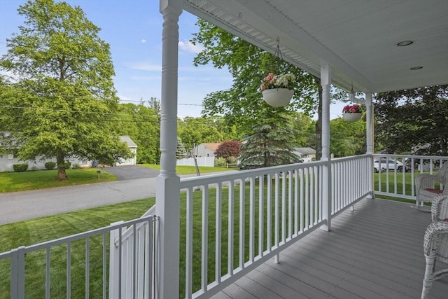 132 Biscayne St, Leominster, MA 01453 - wooden porch featuring a lawn