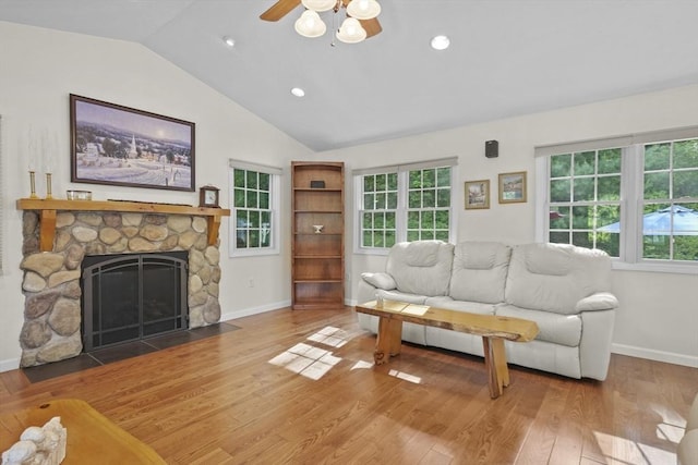 132 Biscayne St, Leominster, MA 01453 - living area featuring wood finished floors, lofted ceiling, a ceiling fan, plenty of natural light, and a fireplace