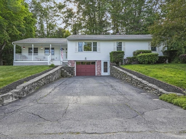 132 Biscayne St, Leominster, MA 01453 - view of front facade with a porch, driveway, an attached garage, and a front yard