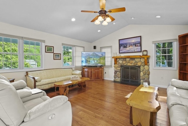 132 Biscayne St, Leominster, MA 01453 - living area with wood finished floors, a stone fireplace, healthy amount of natural light, recessed lighting, and high vaulted ceiling