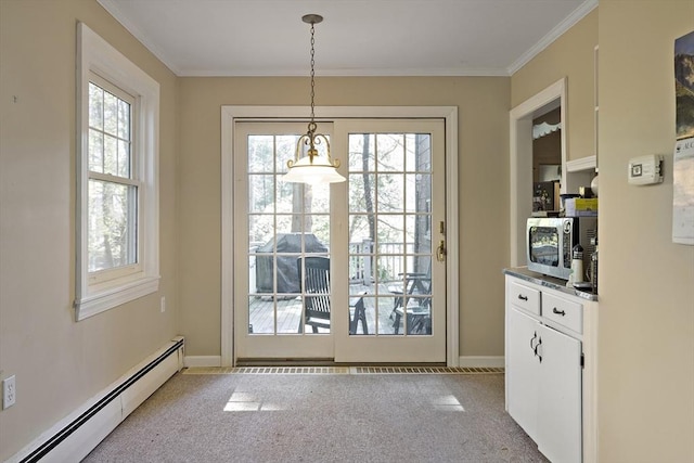 doorway to outside with baseboard heating, carpet, ornamental molding, and baseboards