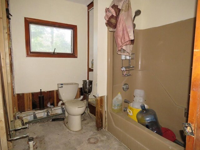 bathroom featuring separate shower and tub, toilet, and concrete floors