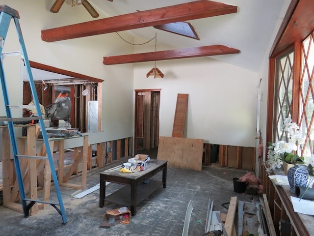 living room with ceiling fan, lofted ceiling with beams, and a healthy amount of sunlight