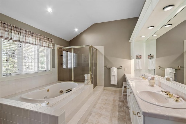 bathroom with a shower stall, a sink, lofted ceiling, and a jetted tub