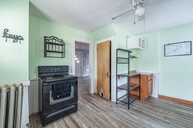 kitchen with electric range, radiator, hardwood / wood-style floors, ceiling fan, and white cabinets