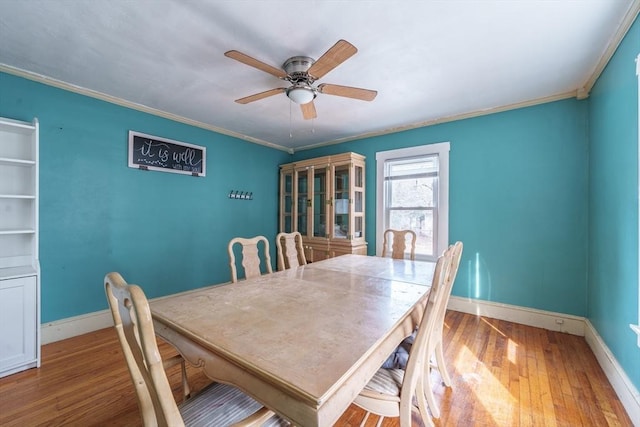 dining area featuring ornamental molding, hardwood / wood-style flooring, and ceiling fan