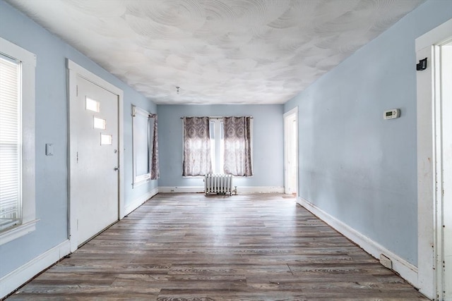 entryway featuring radiator heating unit and hardwood / wood-style floors