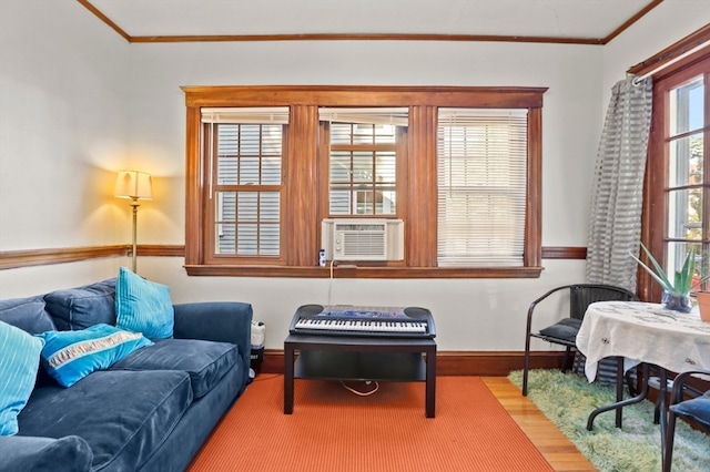 living room featuring cooling unit and ornamental molding