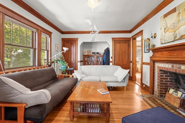 living room with ornamental molding, a fireplace, and light hardwood / wood-style floors