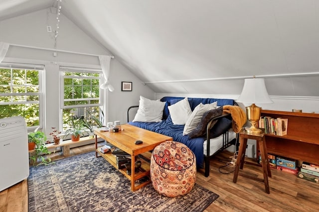 living room with vaulted ceiling and hardwood / wood-style flooring