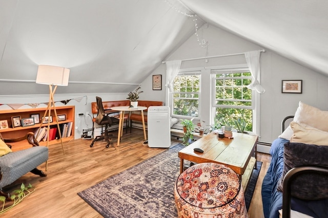 office space with a baseboard heating unit, lofted ceiling, and hardwood / wood-style floors