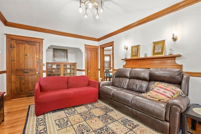 living room with light hardwood / wood-style floors and crown molding