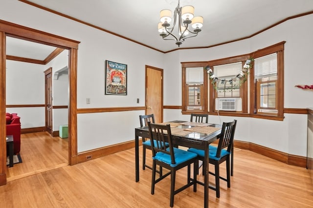 dining area featuring an inviting chandelier, cooling unit, light hardwood / wood-style floors, and crown molding