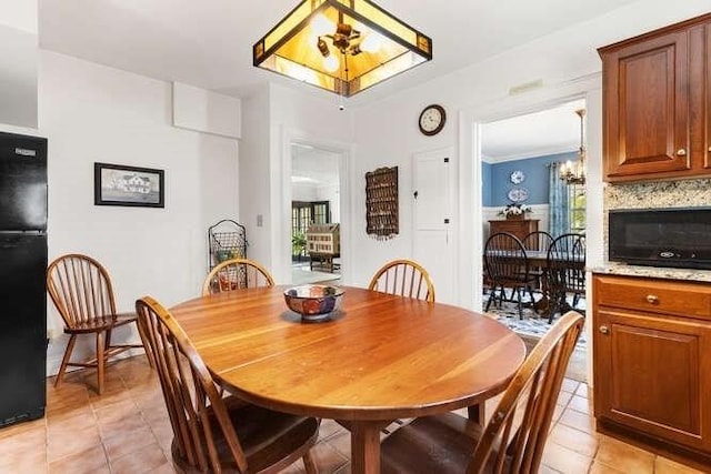 dining space featuring light tile patterned floors and a notable chandelier