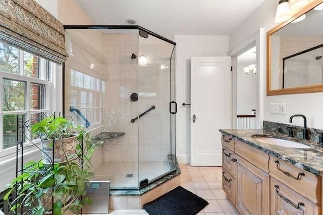 bathroom featuring vanity, tile patterned flooring, and a stall shower